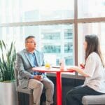 Two Members Networking by Window